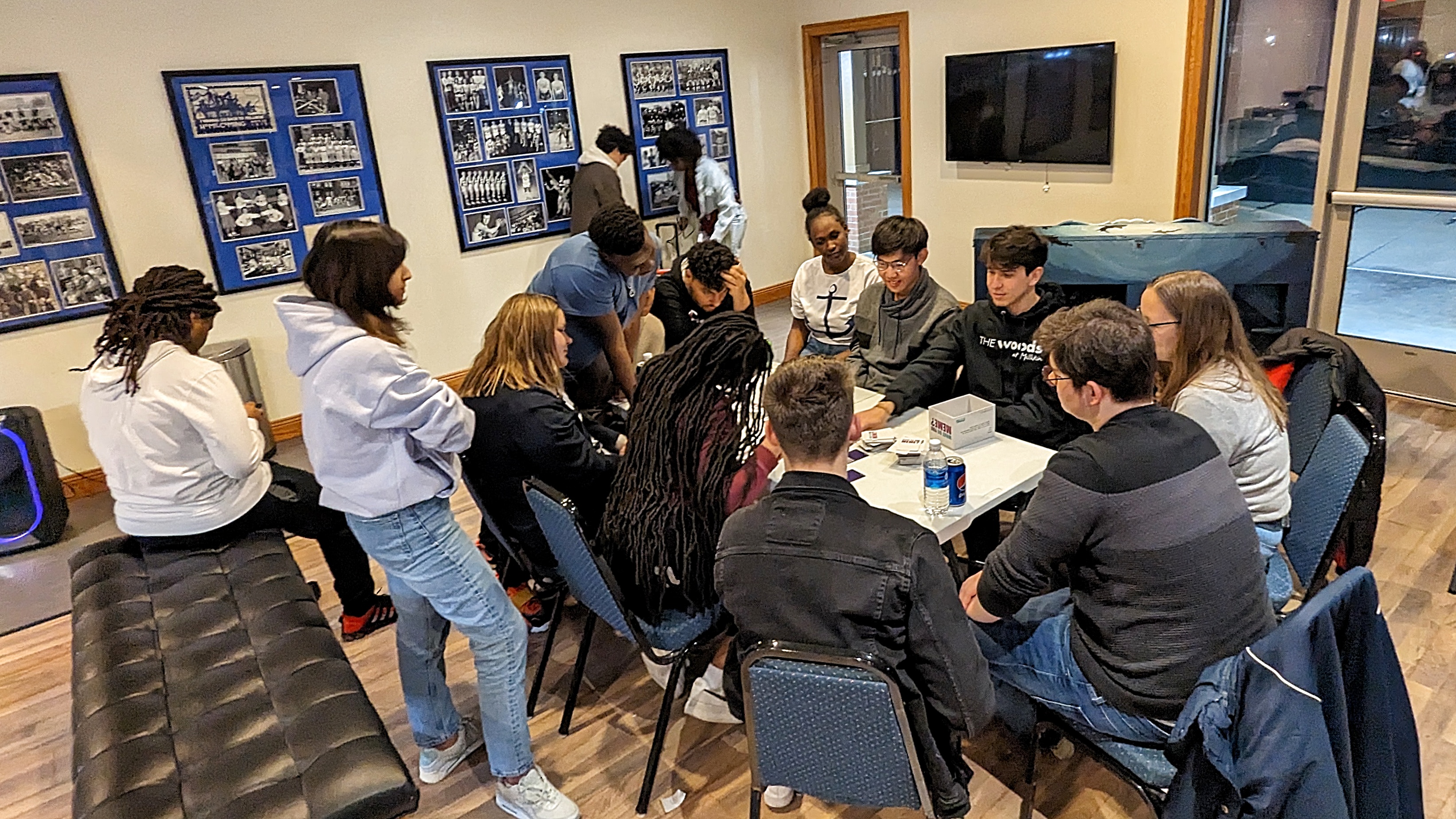 Students sitting at a table playing a card game