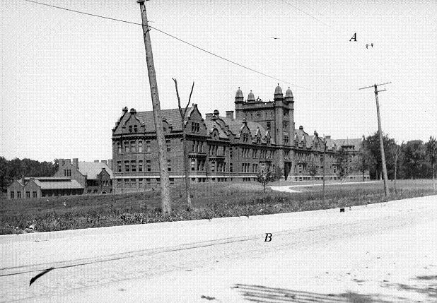 Photo of front campus showing rails and cables on West Main St.