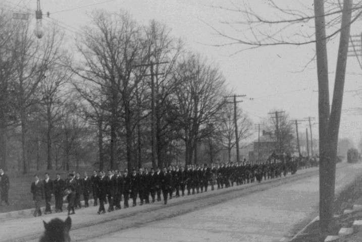 Photograph of James Millikin's body being escorted by students up West Main Street to Millikin University in 1909