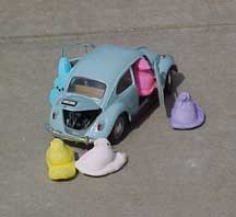 Photo of Peeps exiting a small VW Beetle