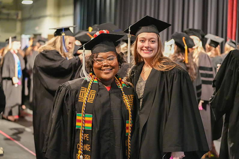 Two graduating students standing together