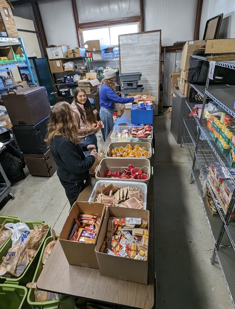 three students sorting food