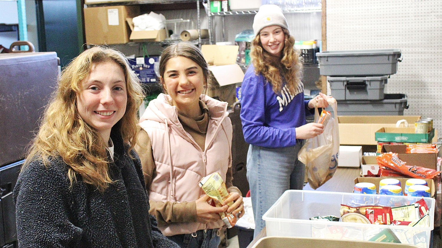 three students sorting food