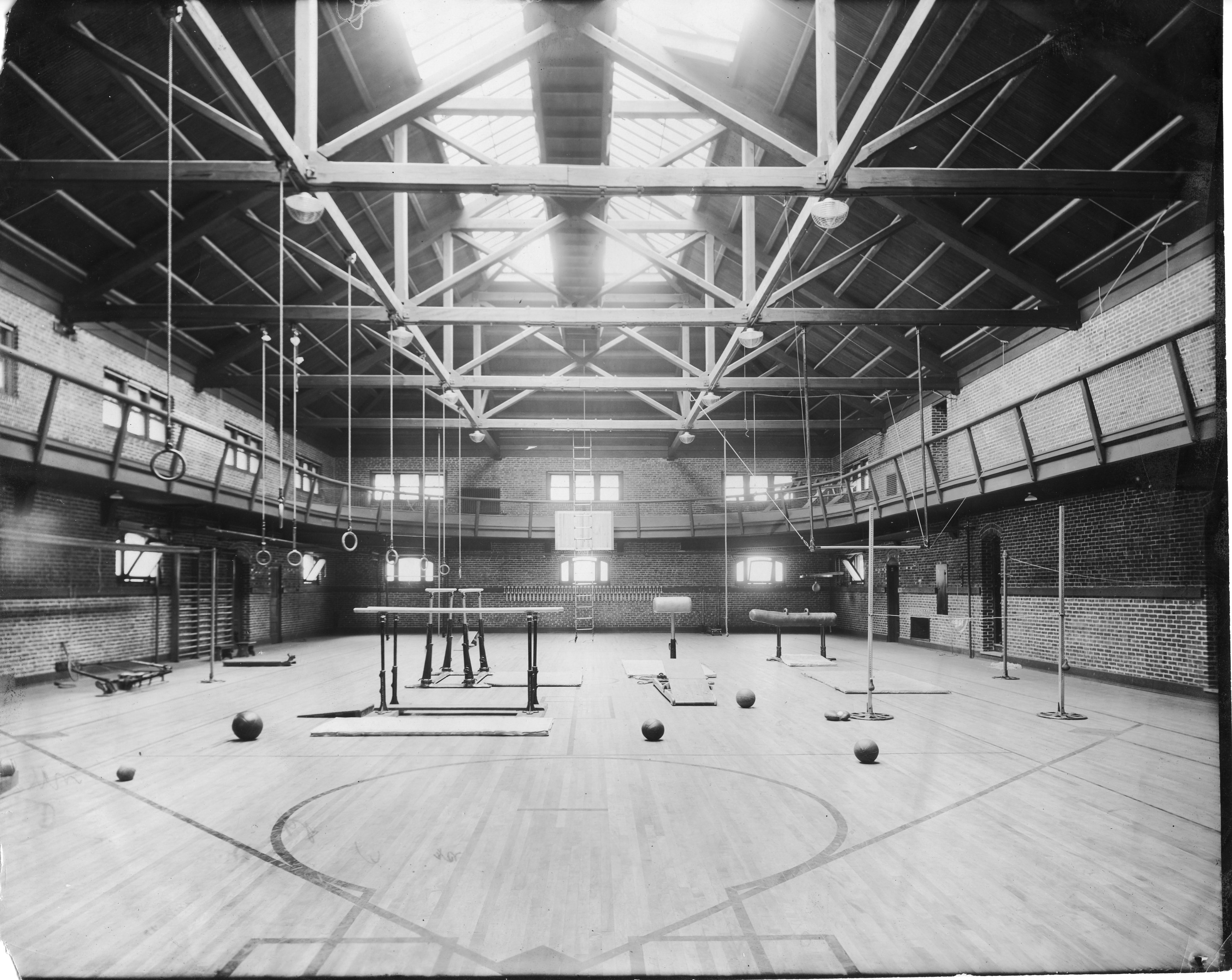 Black and white photo of the basketball court and track of the Old Gym