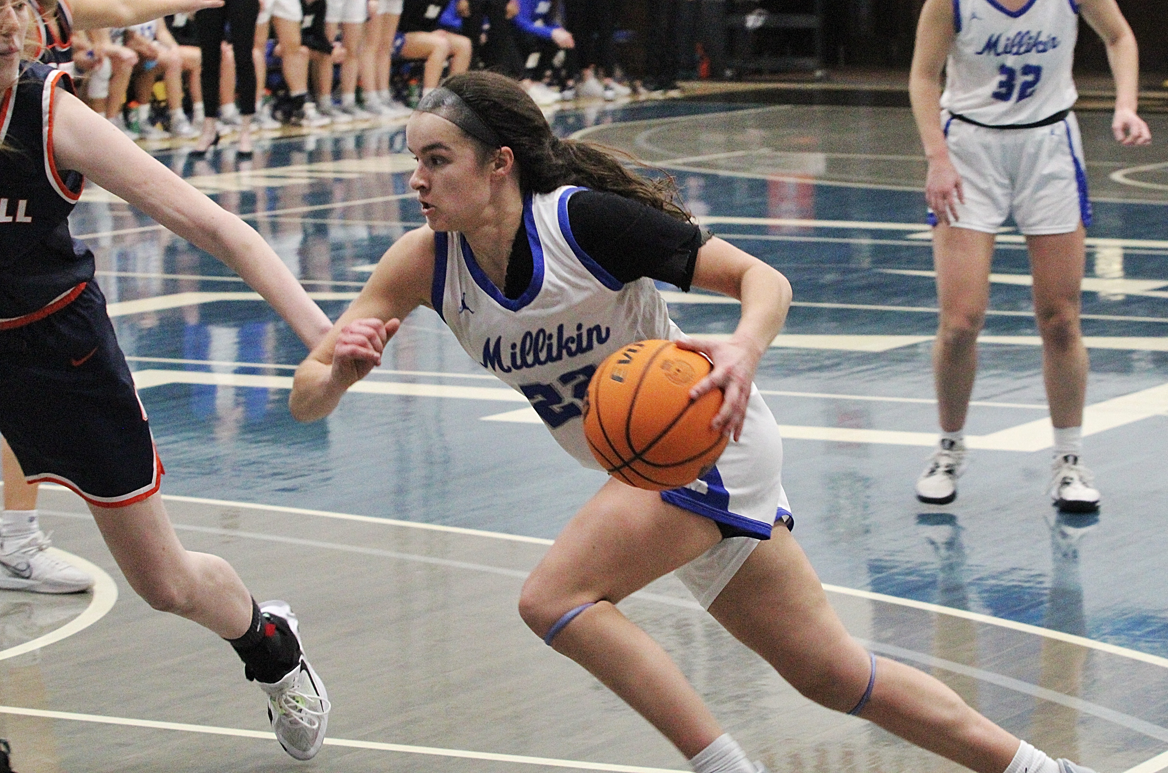 Millikin's Elyce Knudsen (22) heads to the basket against Carroll University.