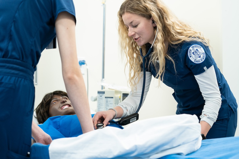 nursing student checking mannequin