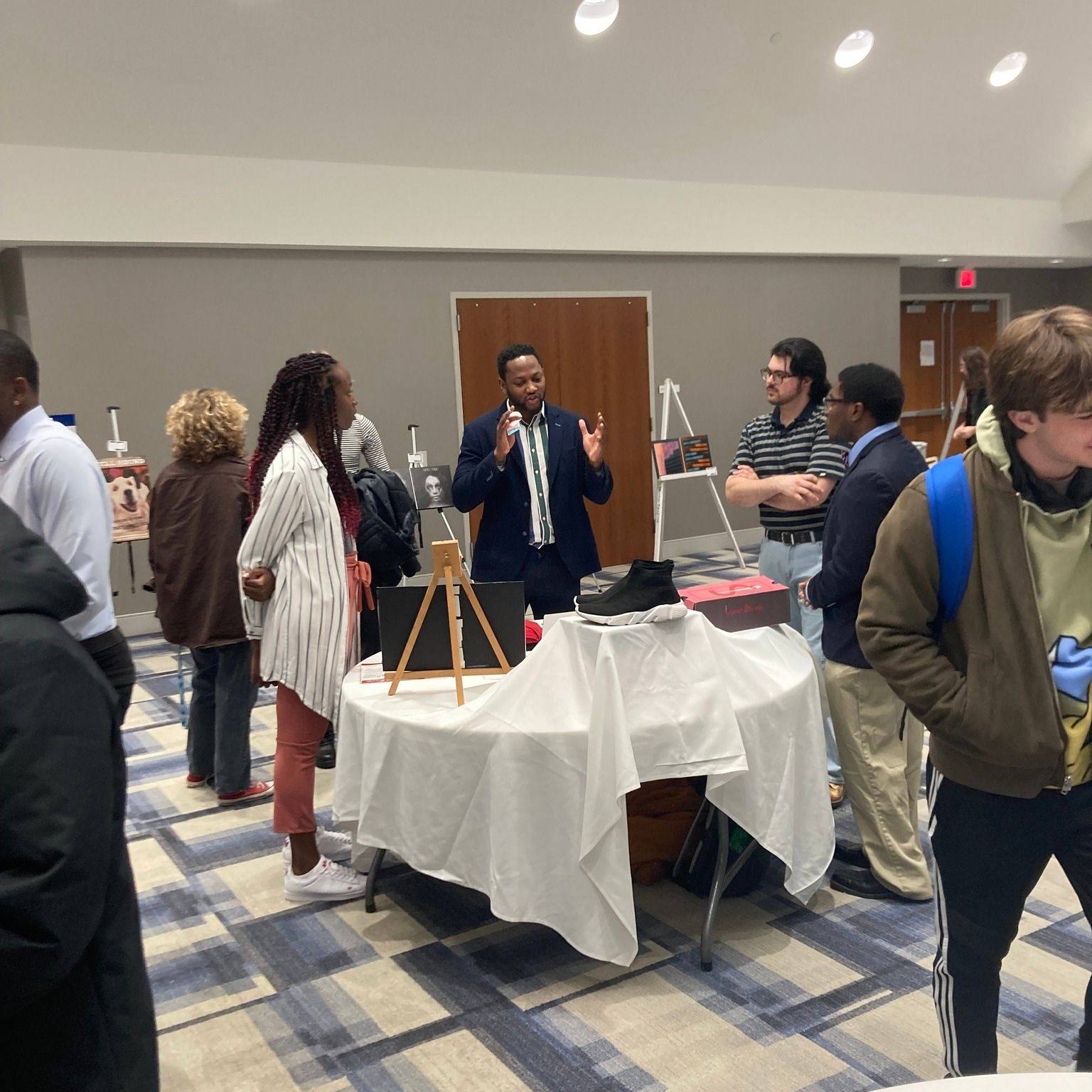 Students surrounding table at expo