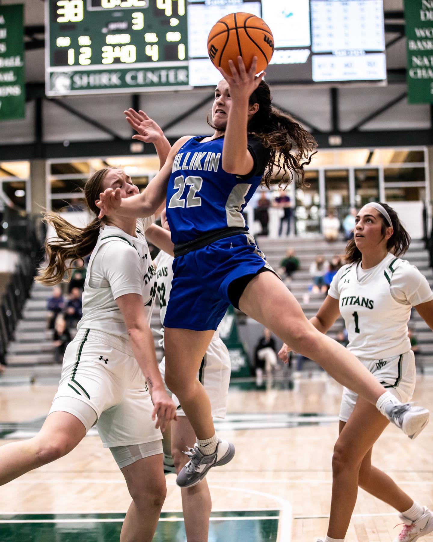 Elyce Knudsen jumping for a layup