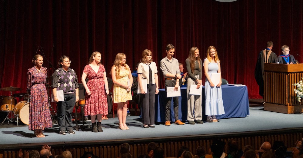 students lined up on stage