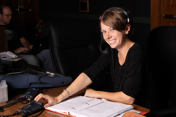 theatre student smiling sitting at desk