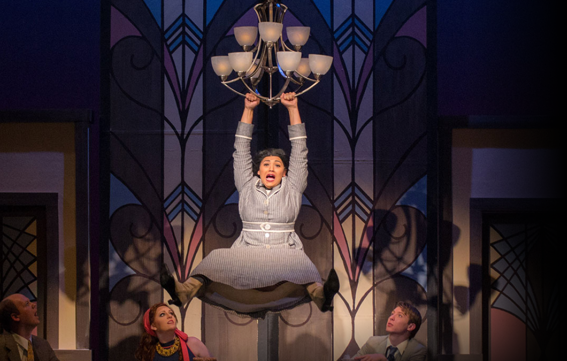 woman hanging from a chandelier