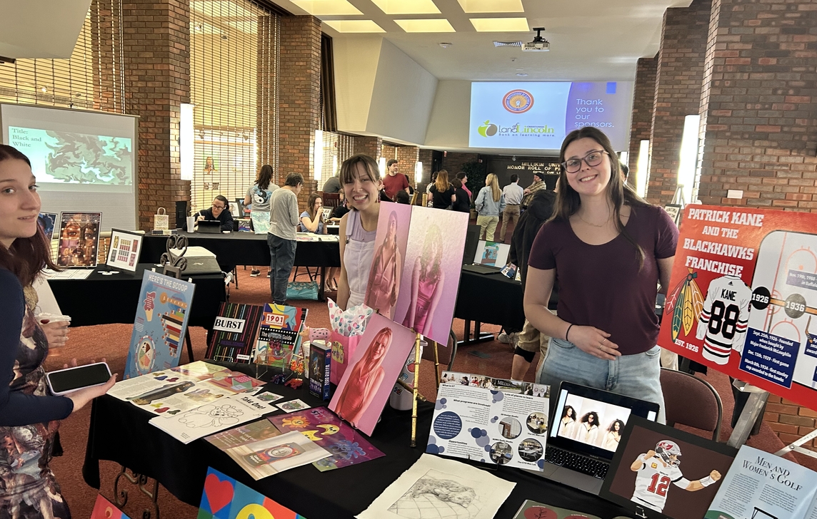 Student displays their work in the lobby of Kirkland Fine Arts Center