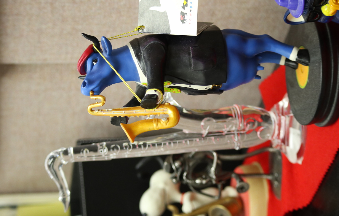 A figurine of a cow playing saxophone!