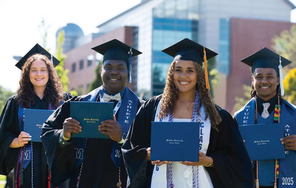 Graduates with diplomas