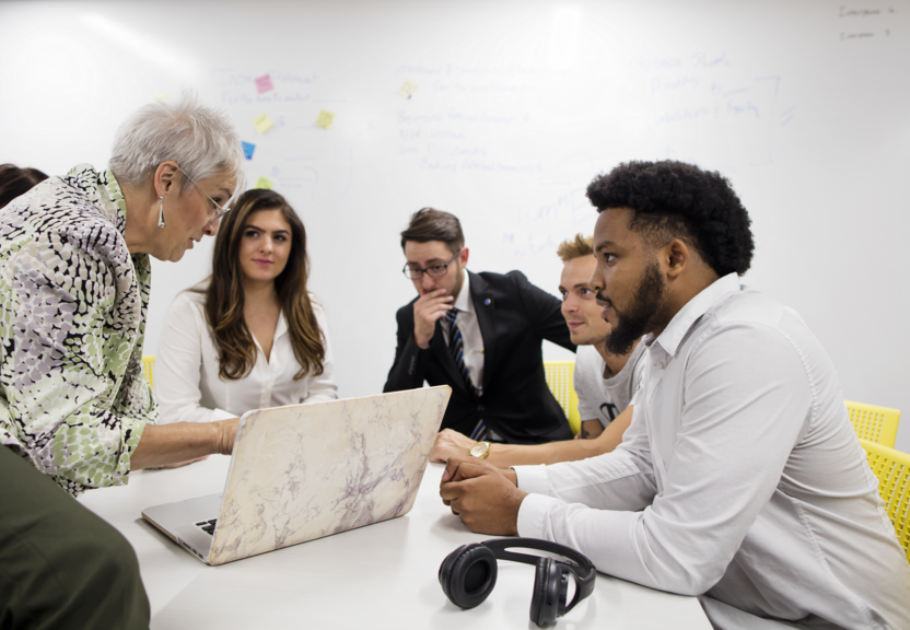 Accounting-students-working-with-a-professor