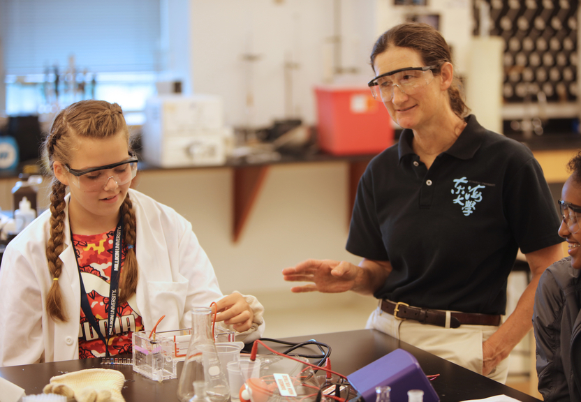 Teacher advising biology student