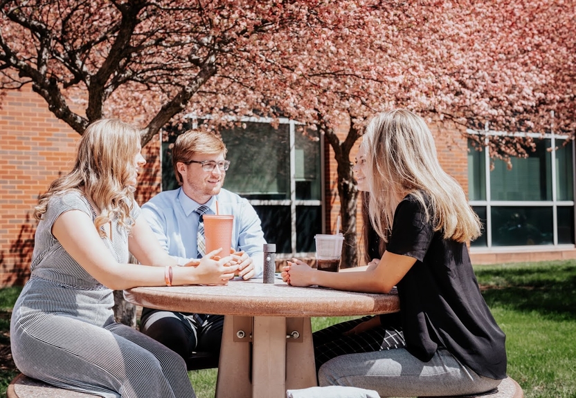 Four Students sitting and talking 