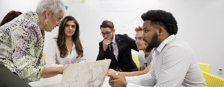 Accounting-students-working-with-a-professor