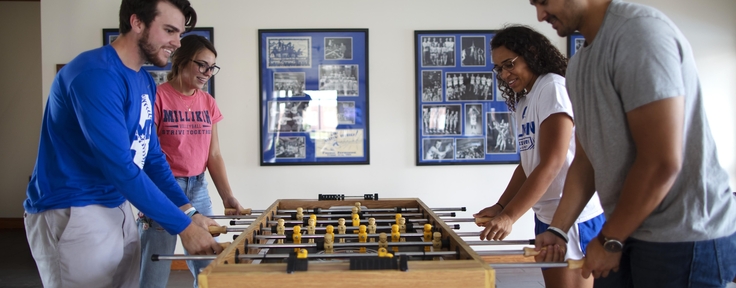 Students playing Foosball