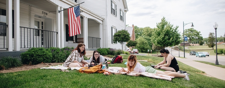 students outside of sorority house