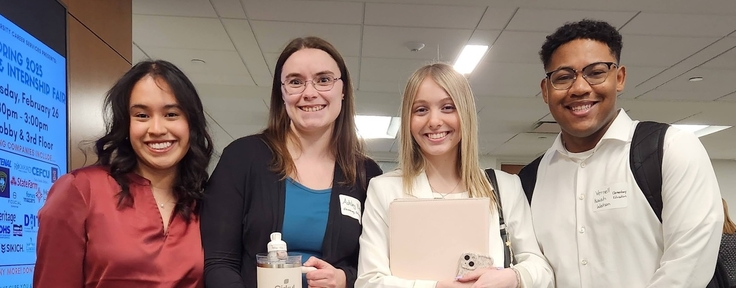 four students smiling