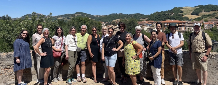 people standing for group photo italy countryside