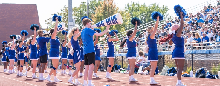 cheerleaders in front of bleachers