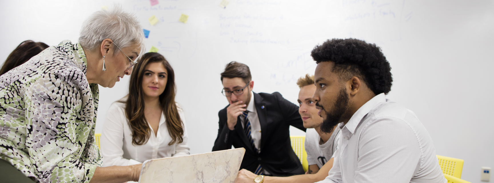 Accounting-students-working-with-a-professor