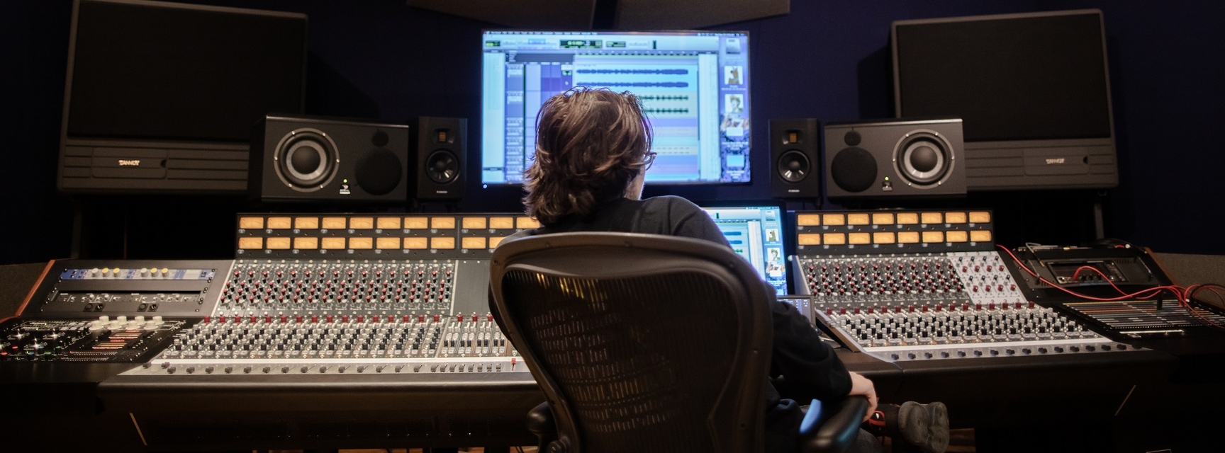 Student sitting at sound board