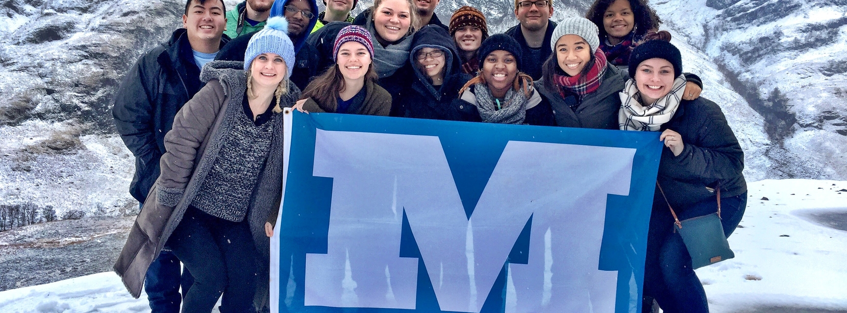 Students holding up a Millikin flag