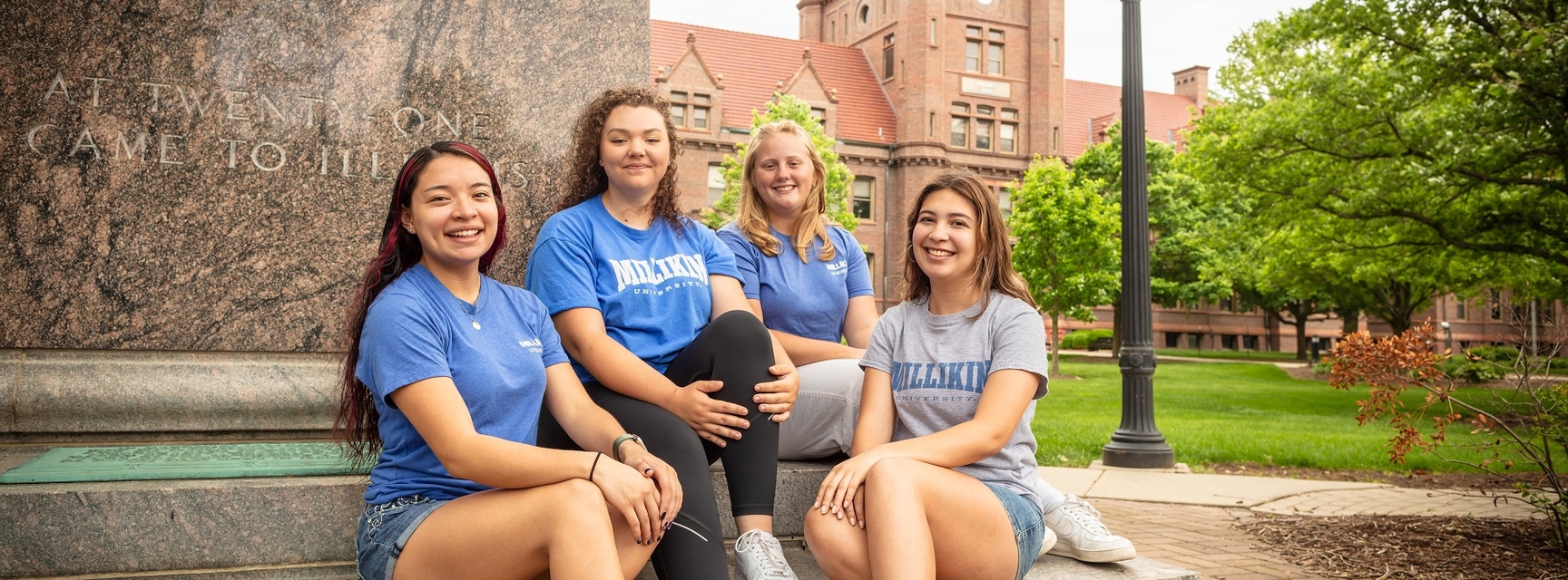 Group of girls sitting on campus