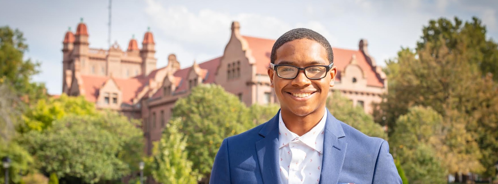 person standing with shilling hall in background