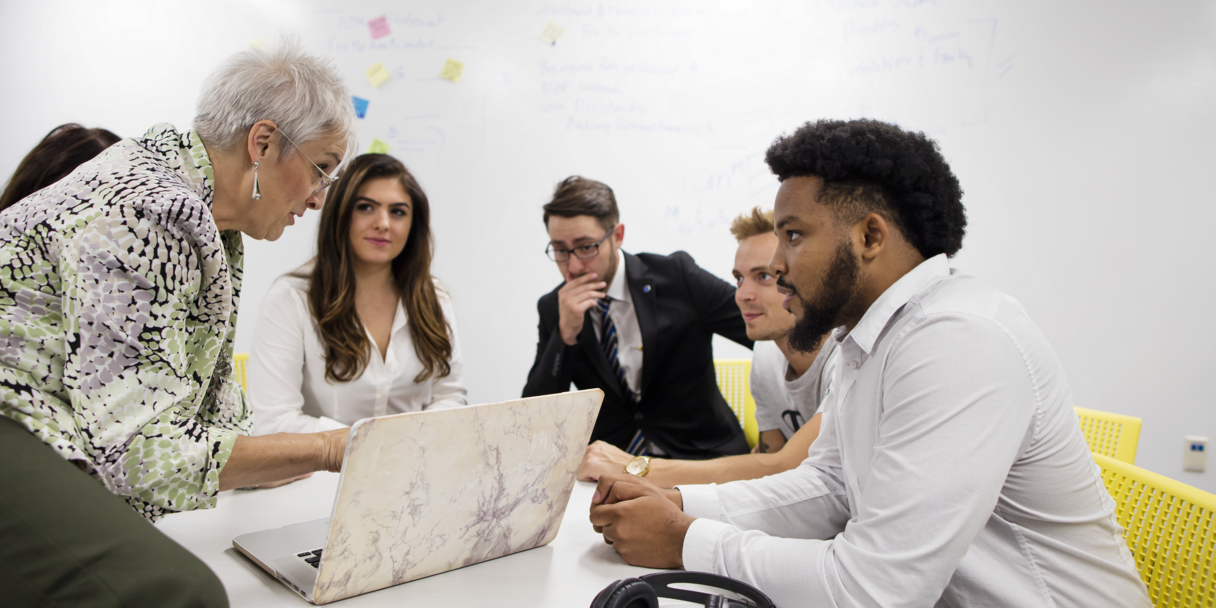 Accounting-students-working-with-a-professor
