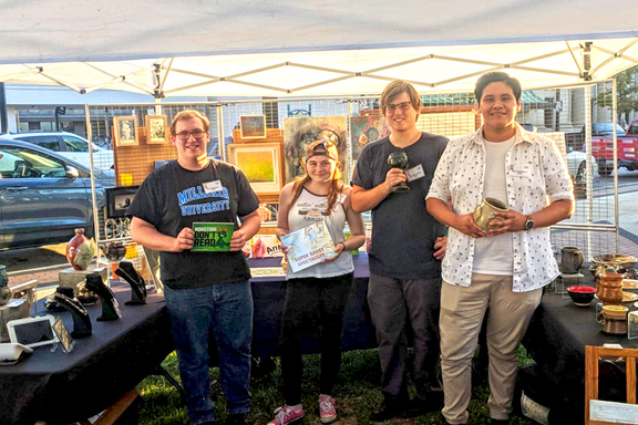 Students holding art