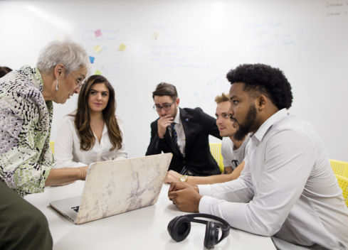 Accounting-students-working-with-a-professor