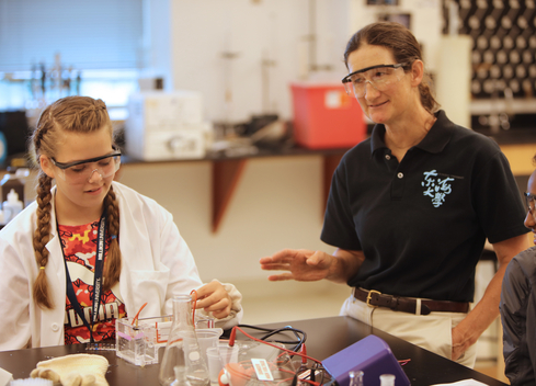 Teacher advising biology student