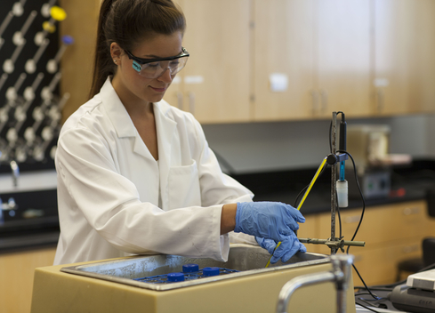 Student with lab equipment