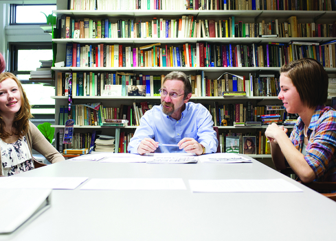 four students at a table talking