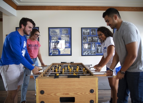 Students playing Foosball