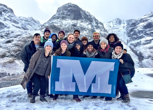 Students holding up a Millikin flag