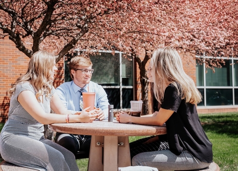 Four Students sitting and talking 