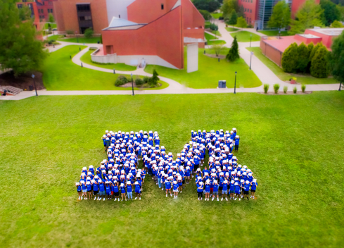 Students forming an M on quad