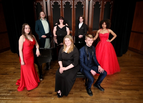 Student members of the Millikin Opera Gala pose on the stage of Kaeuper Hall