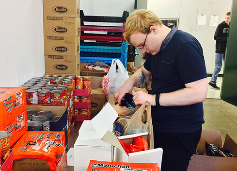 student filling bags with food