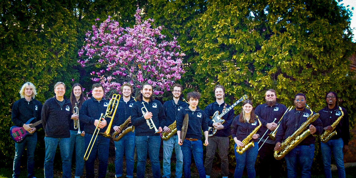 Jazz I poses in front of trees.