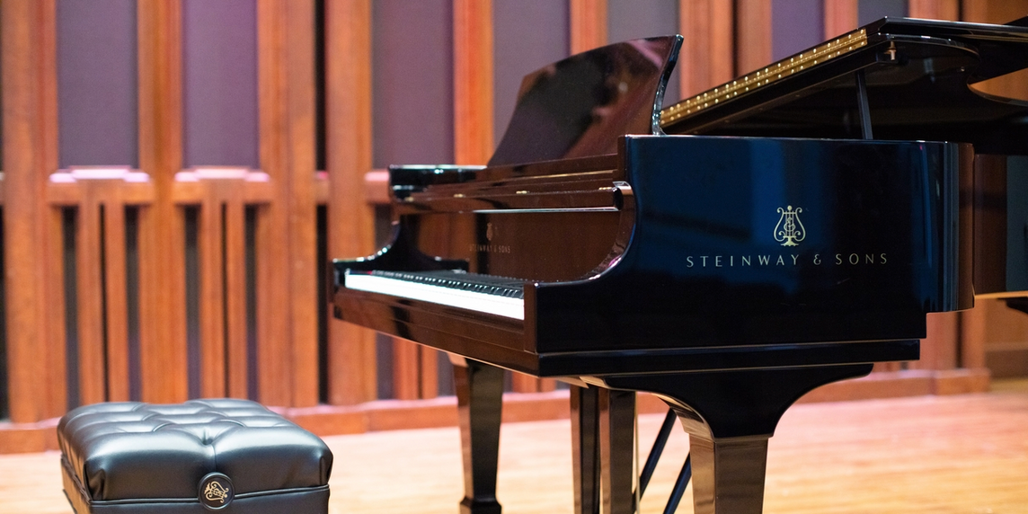 A grand piano on stage in Kaeuper Hall.